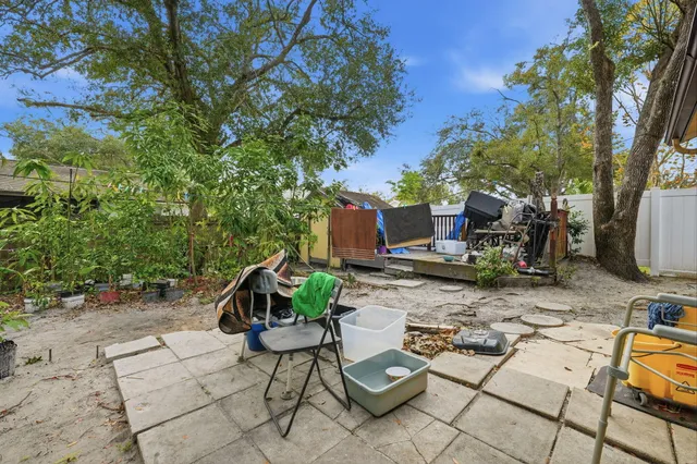 a view of backyard with furniture and a fire pit