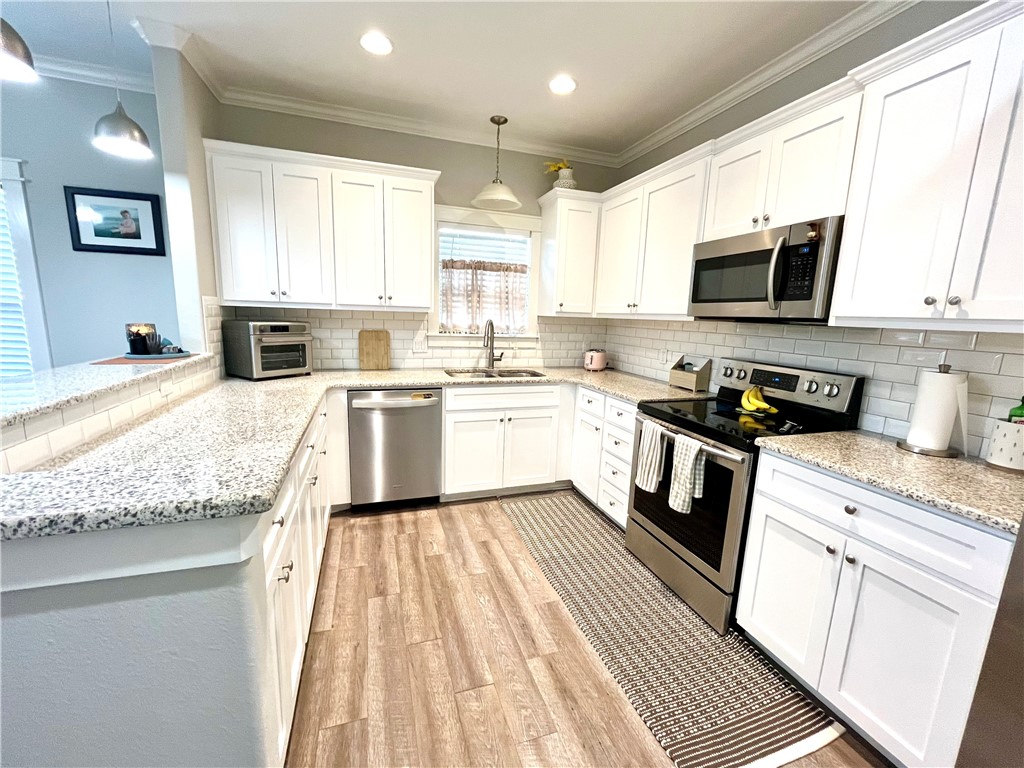 344 Bay View Boulevard, Unit A Portland, TX 78374 - Photo 3 of 8 a kitchen with a sink stove top oven and refrigerator