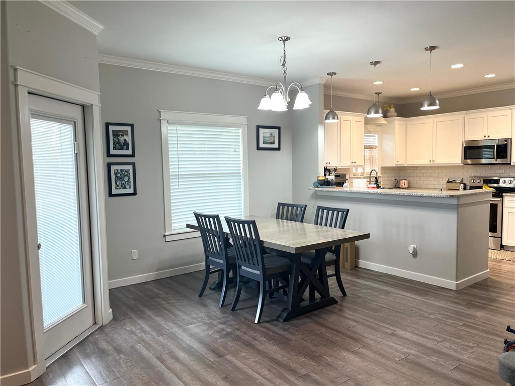 344 Bay View Boulevard, Unit A Portland, TX 78374 - Photo 6 of 8 a view of a dining room with furniture window and wooden floor