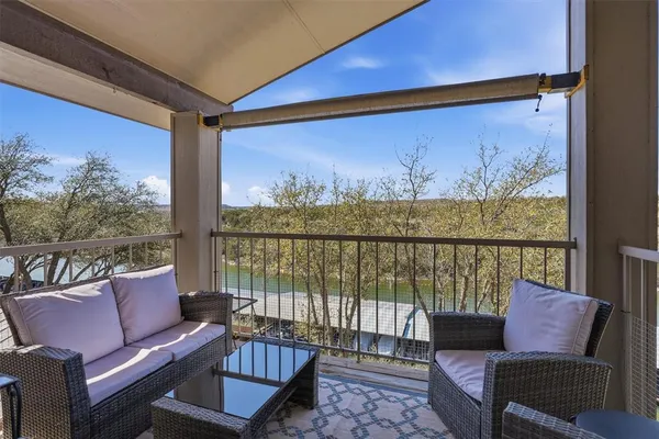 a view of a chairs and table in the balcony
