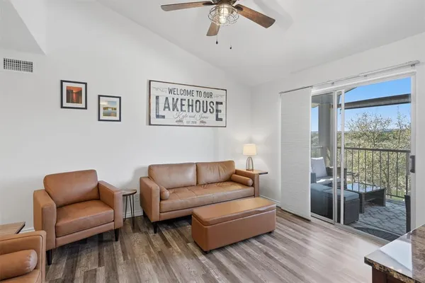 a living room with furniture ceiling fan and a window