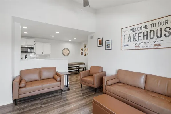 a living room with furniture and a wooden floor