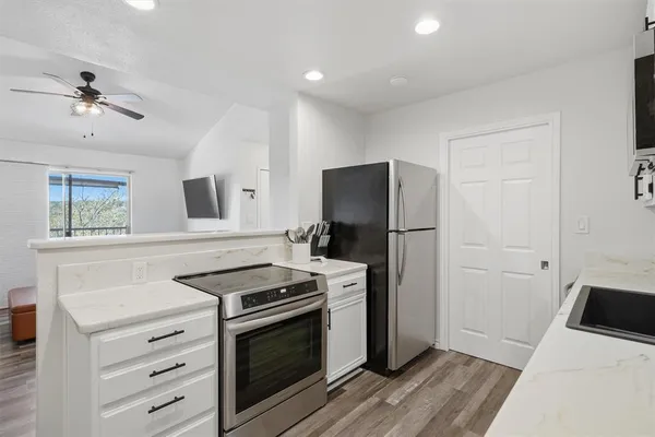 a kitchen with a stove microwave and a refrigerator