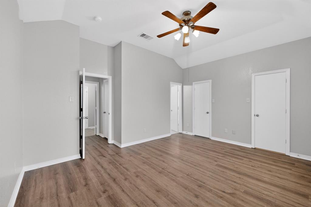 3401 Newgate Street Midlothian, TX 76065 - Photo 22 of 34 Spacious room featuring wood-finish flooring, vaulted ceiling, and a ceiling fan with integrated lighting