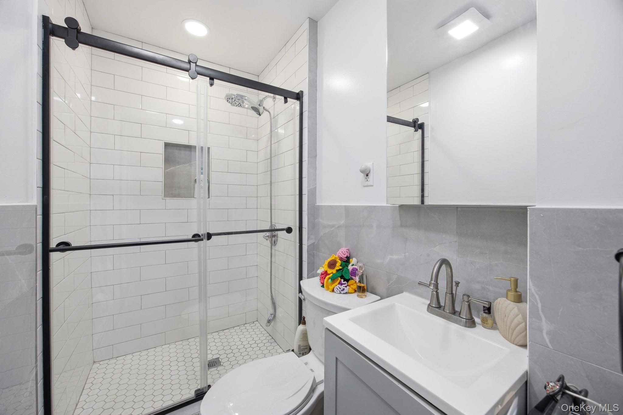 49-12 111th Street Queens, NY 11368 - Photo 11 of 31 a bathroom with a sink toilet and shower