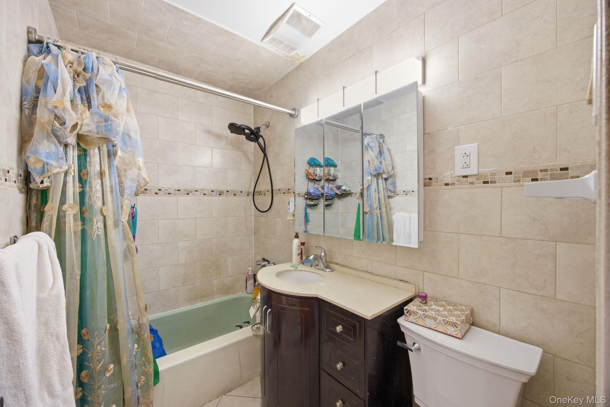 49-12 111th Street Queens, NY 11368 - Photo 13 of 31 a bathroom with a granite countertop sink toilet and shower