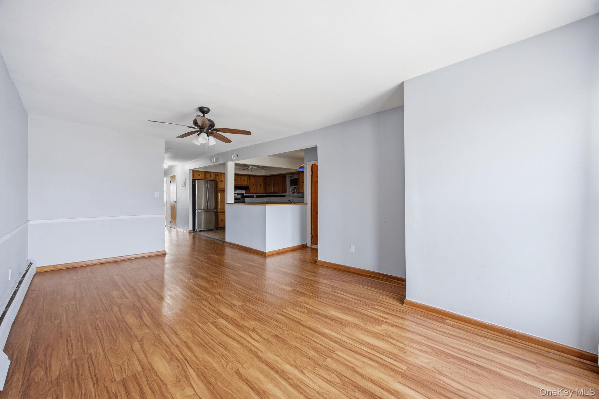 49-12 111th Street Queens, NY 11368 - Photo 17 of 31 a view of empty room with wooden floor