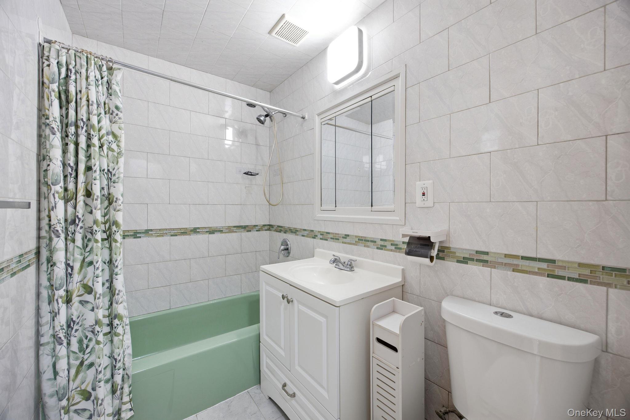 49-12 111th Street Queens, NY 11368 - Photo 20 of 31 a bathroom with a sink a toilet and shower