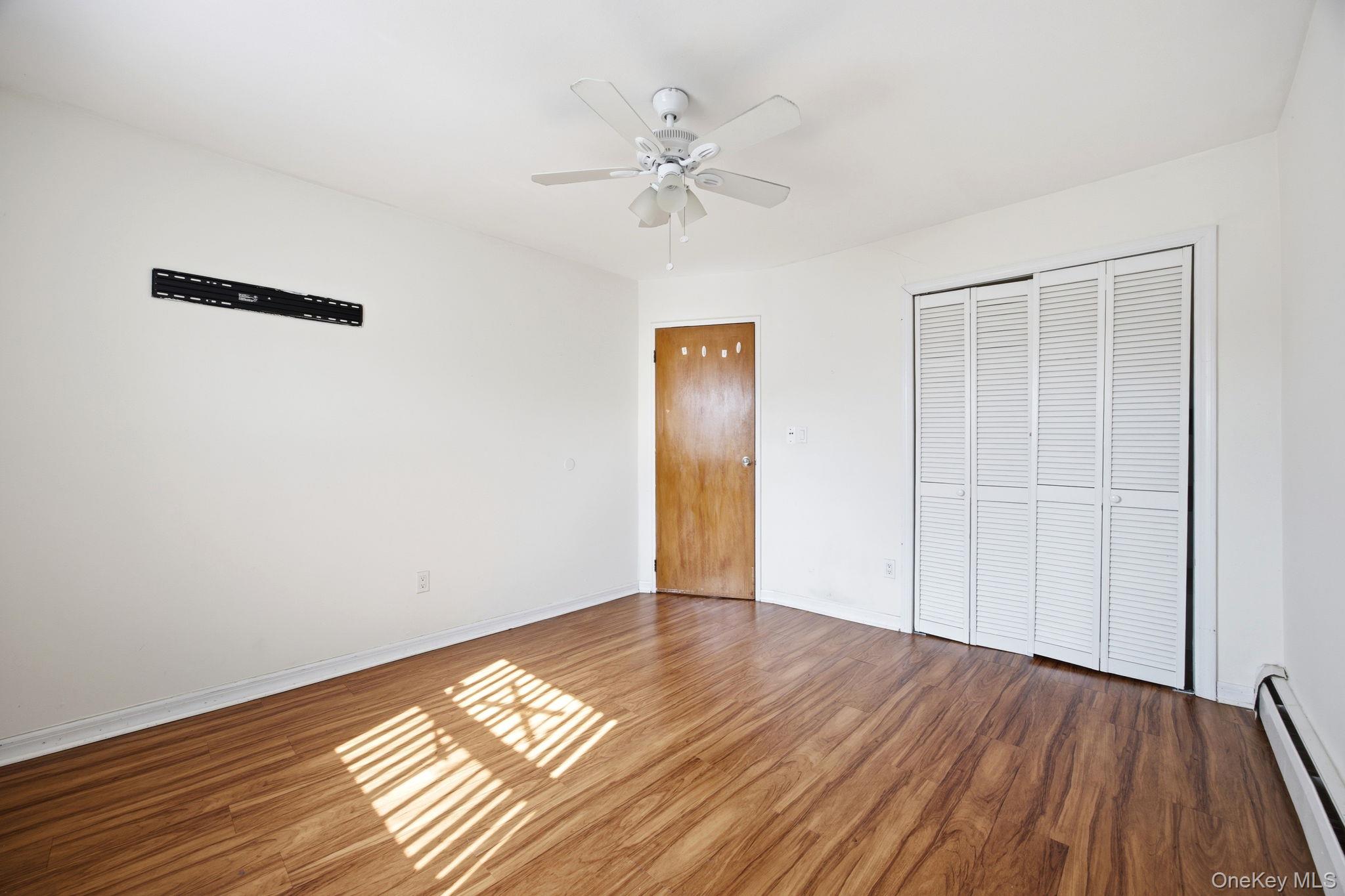 49-12 111th Street Queens, NY 11368 - Photo 22 of 31 a view of wooden floor in an empty room