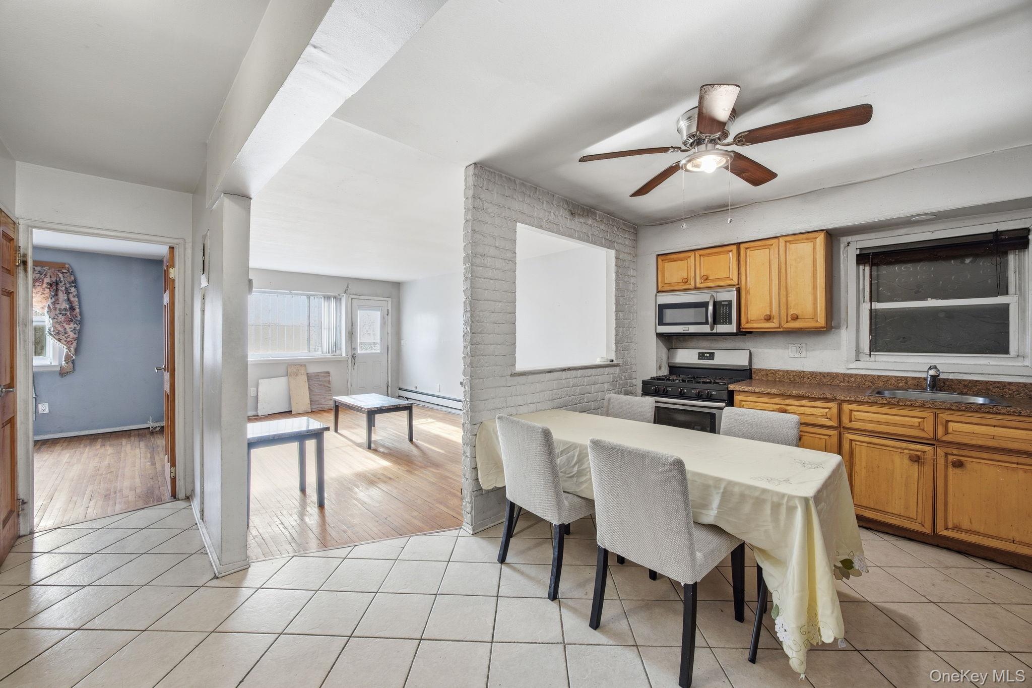 49-12 111th Street Queens, NY 11368 - Photo 3 of 31 a view of a dining room with furniture window and wooden floor