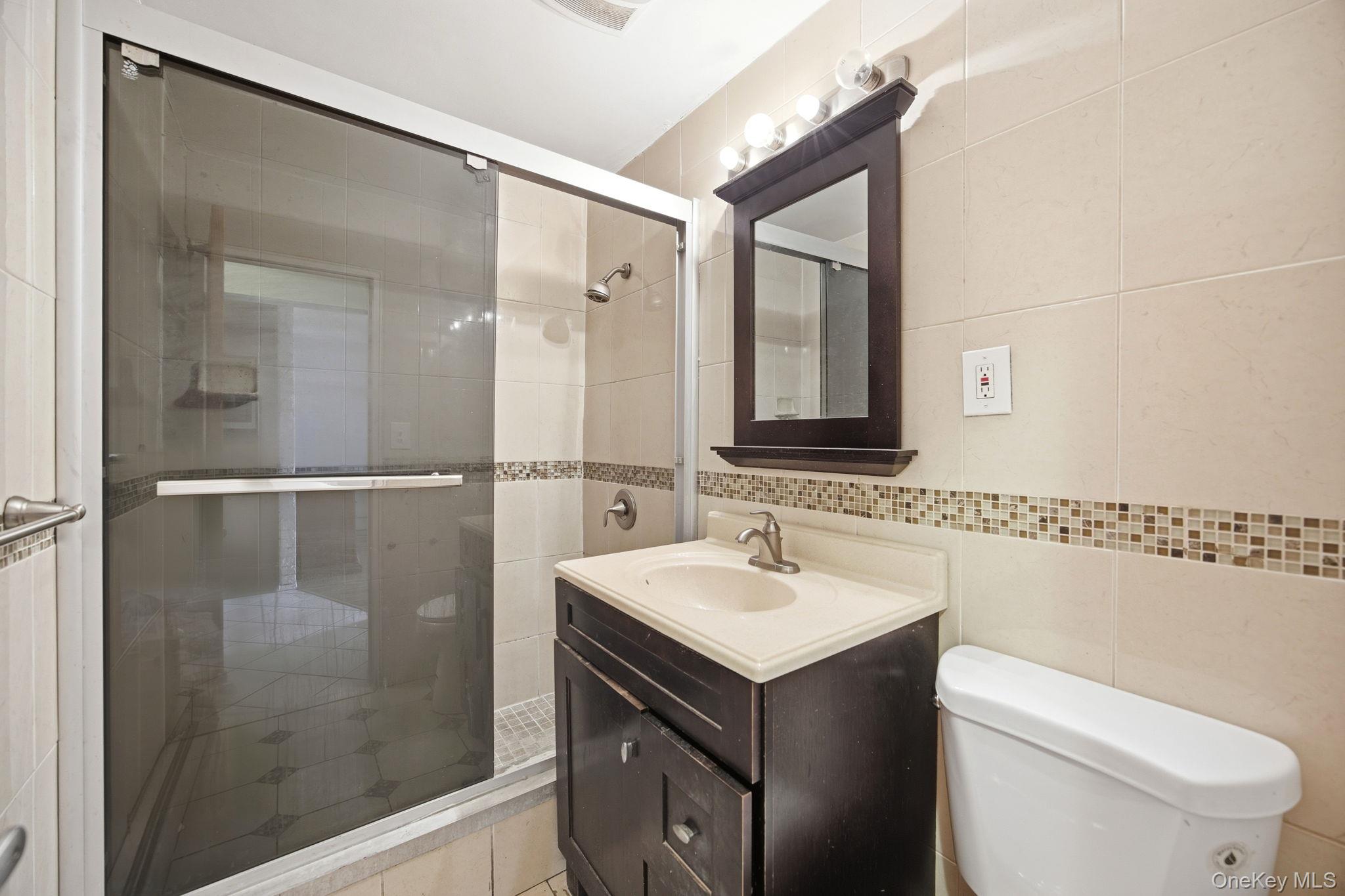 49-12 111th Street Queens, NY 11368 - Photo 4 of 31 a bathroom with a sink toilet and shower