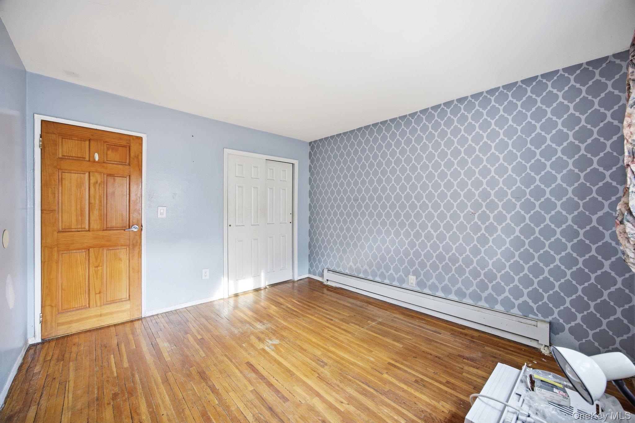 49-12 111th Street Queens, NY 11368 - Photo 5 of 31 a view of empty room with wooden floor