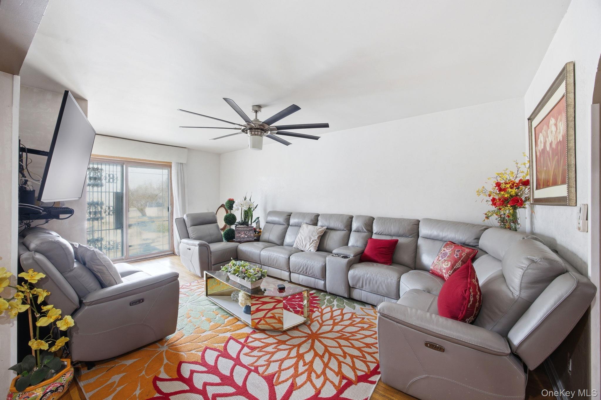 49-12 111th Street Queens, NY 11368 - Photo 8 of 31 a living room with furniture and a large window
