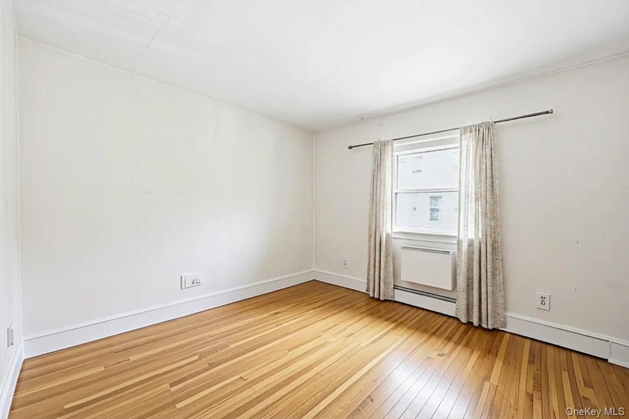 49-12 111th Street Queens, NY 11368 - Photo 10 of 31 a view of empty room with wooden floor