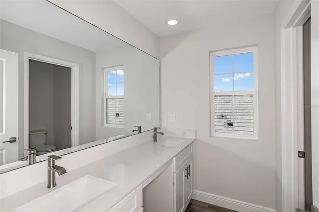 a view of a bathroom with a sink and wooden floor