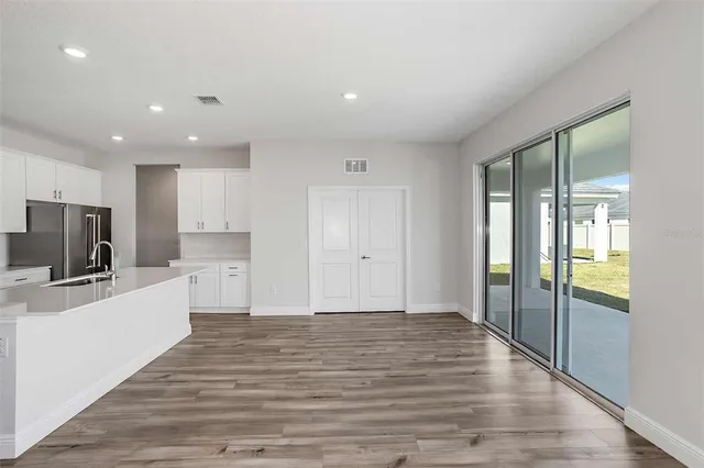 a view of a kitchen with a sink and a refrigerator