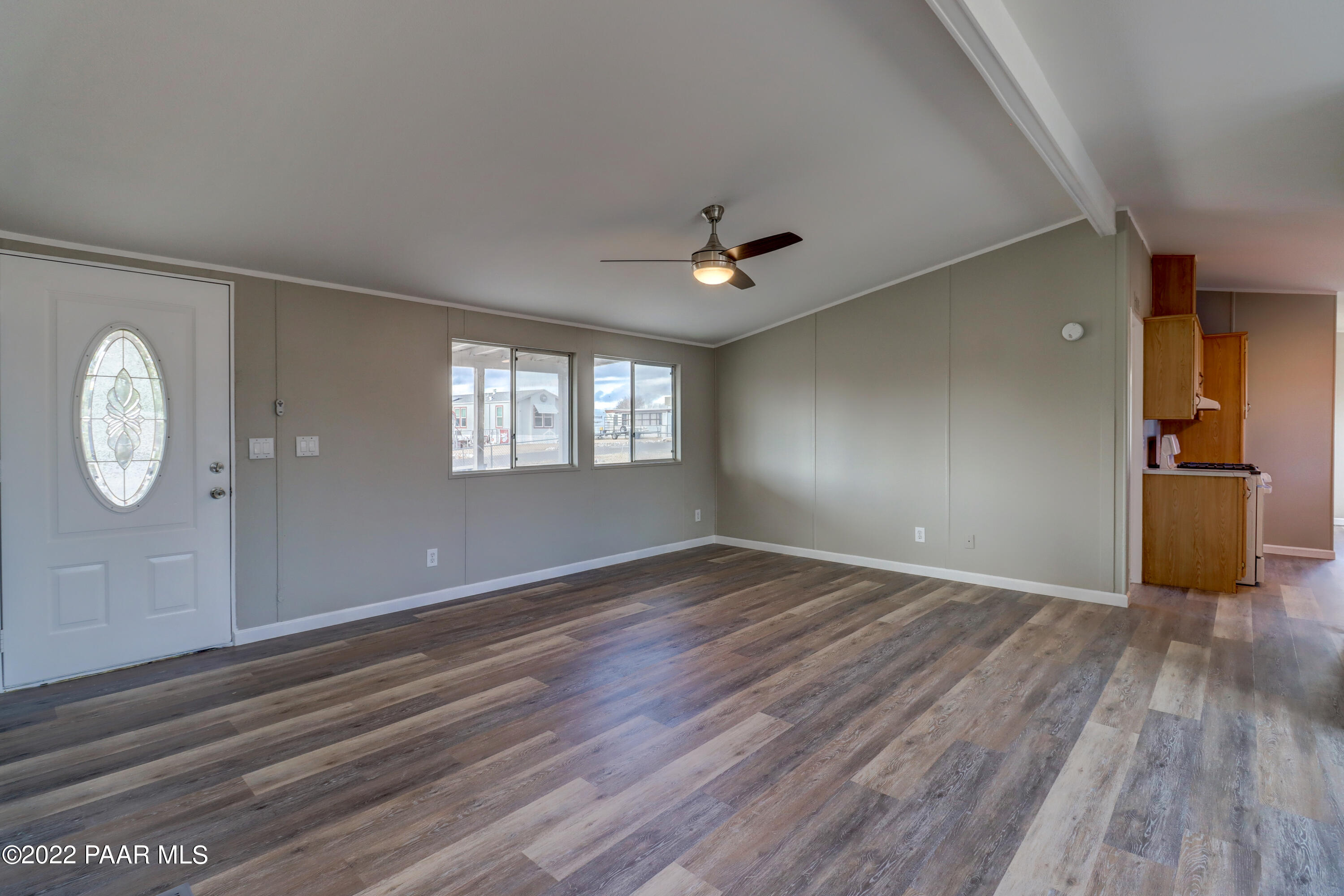 1330 Prairiegrass Road Chino Valley, AZ 86323 - Photo 11 of 31 an empty room with wooden floor and windows