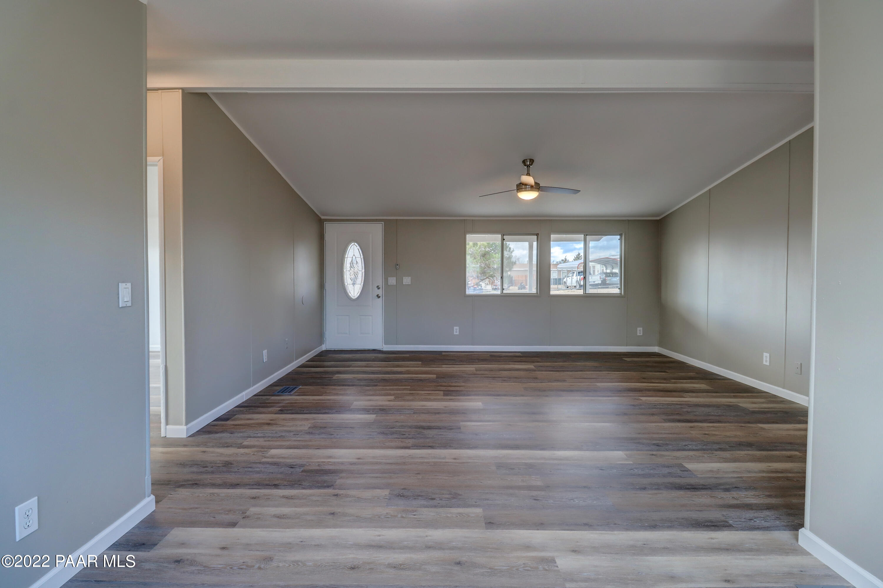 1330 Prairiegrass Road Chino Valley, AZ 86323 - Photo 12 of 31 a view of an empty room with wooden floor and a window
