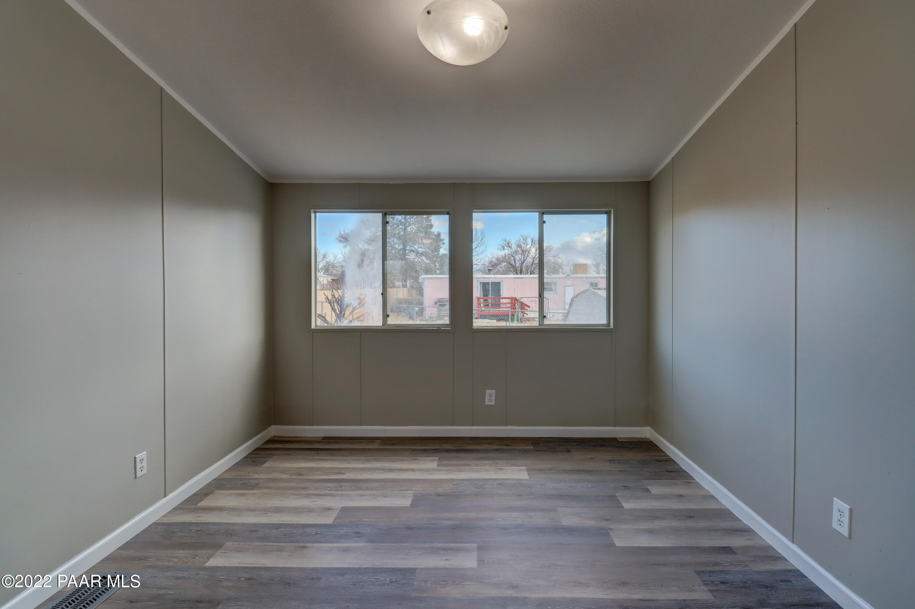1330 Prairiegrass Road Chino Valley, AZ 86323 - Photo 13 of 31 an empty room with wooden floor and windows
