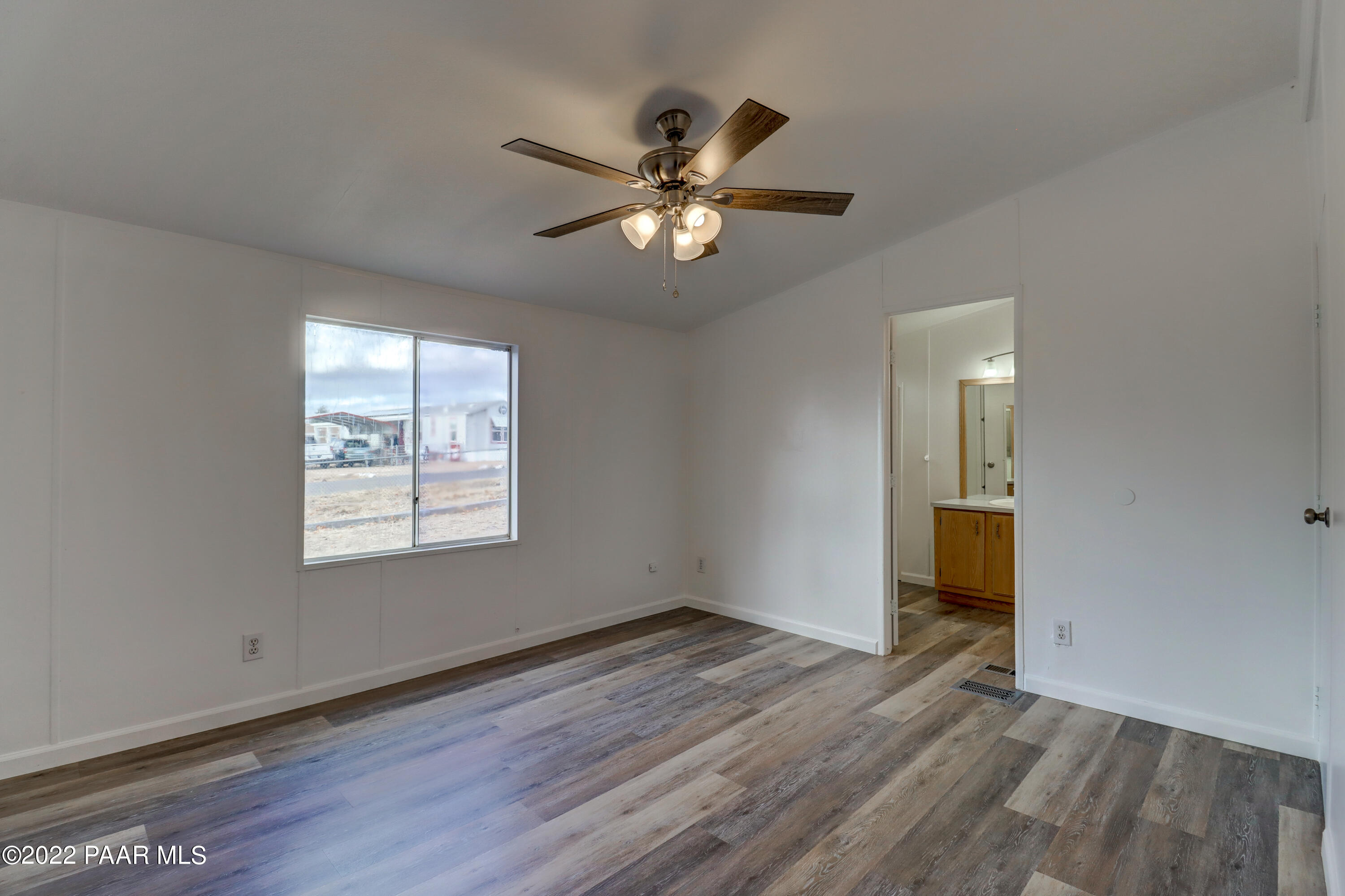 1330 Prairiegrass Road Chino Valley, AZ 86323 - Photo 17 of 31 wooden floor in an empty room with a window
