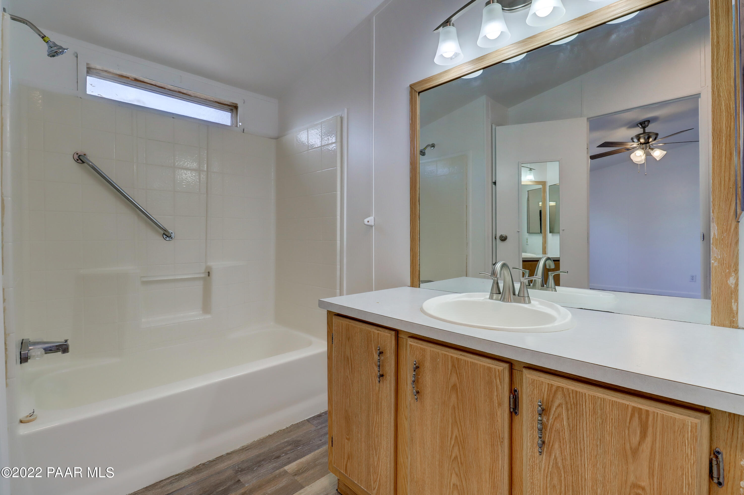1330 Prairiegrass Road Chino Valley, AZ 86323 - Photo 18 of 31 a bathroom with a sink double vanity mirror and a bathtub