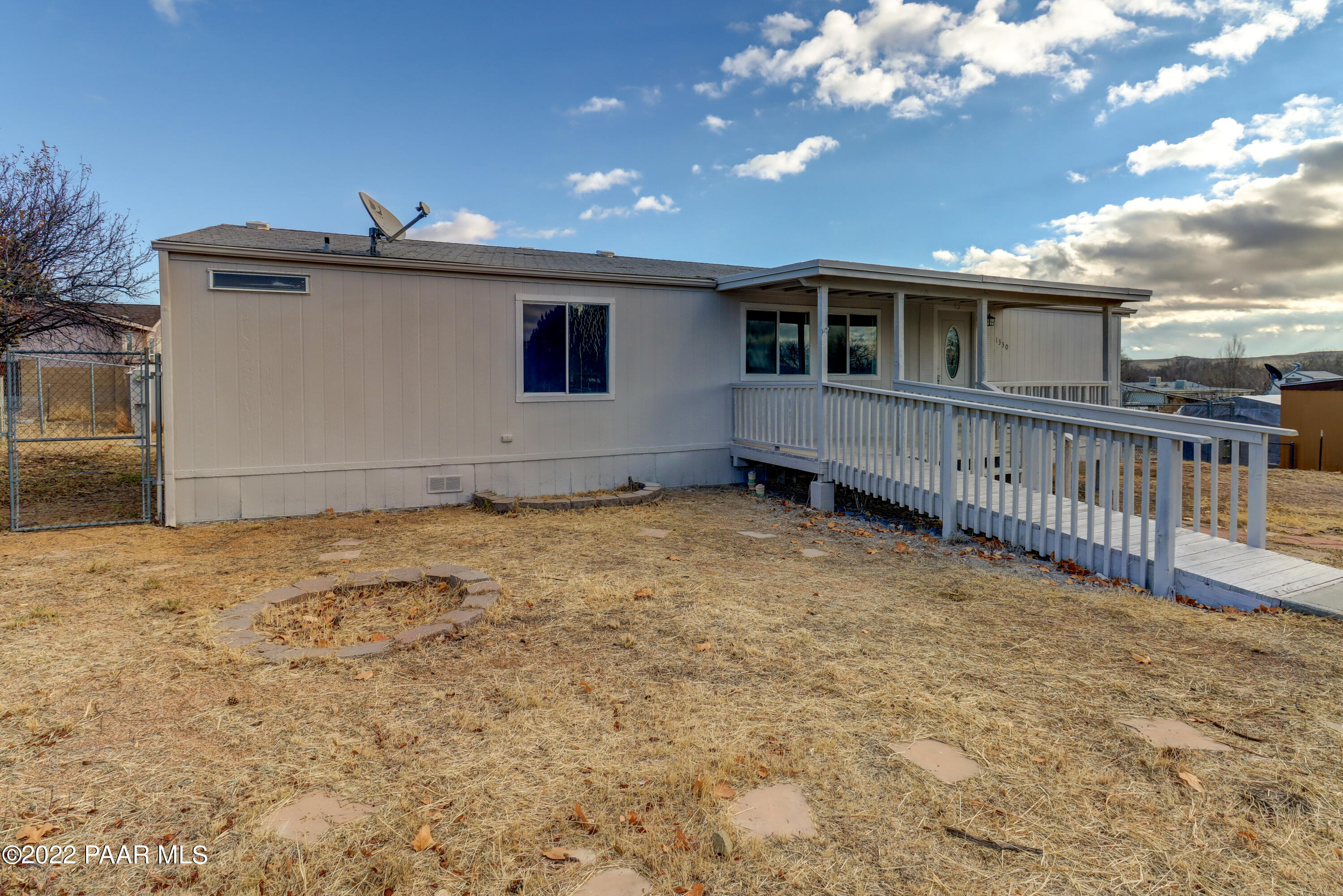 1330 Prairiegrass Road Chino Valley, AZ 86323 - Photo 23 of 31 a view of a house with a wooden fence