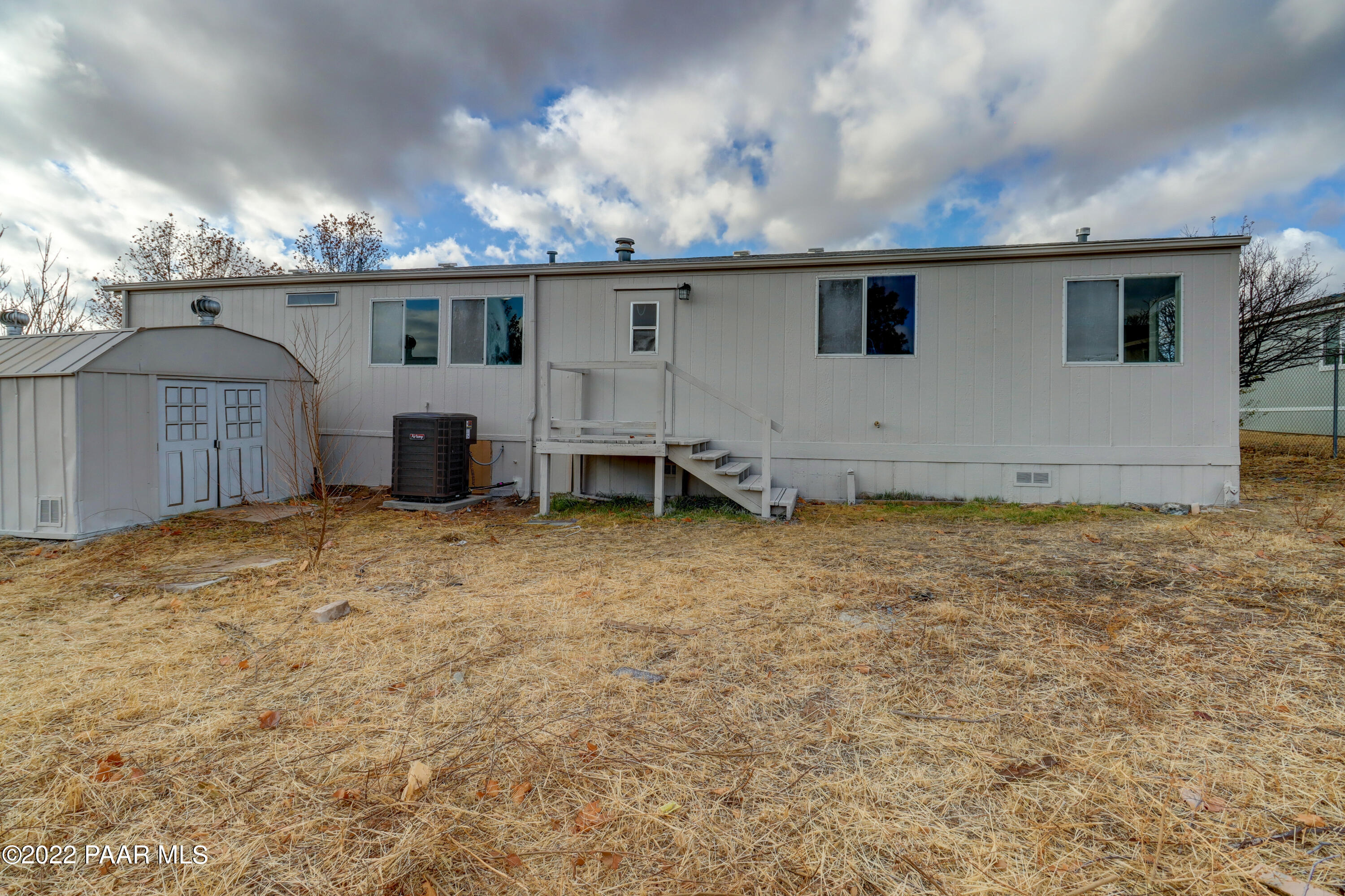 1330 Prairiegrass Road Chino Valley, AZ 86323 - Photo 27 of 31 a view of a house with backyard and a tree