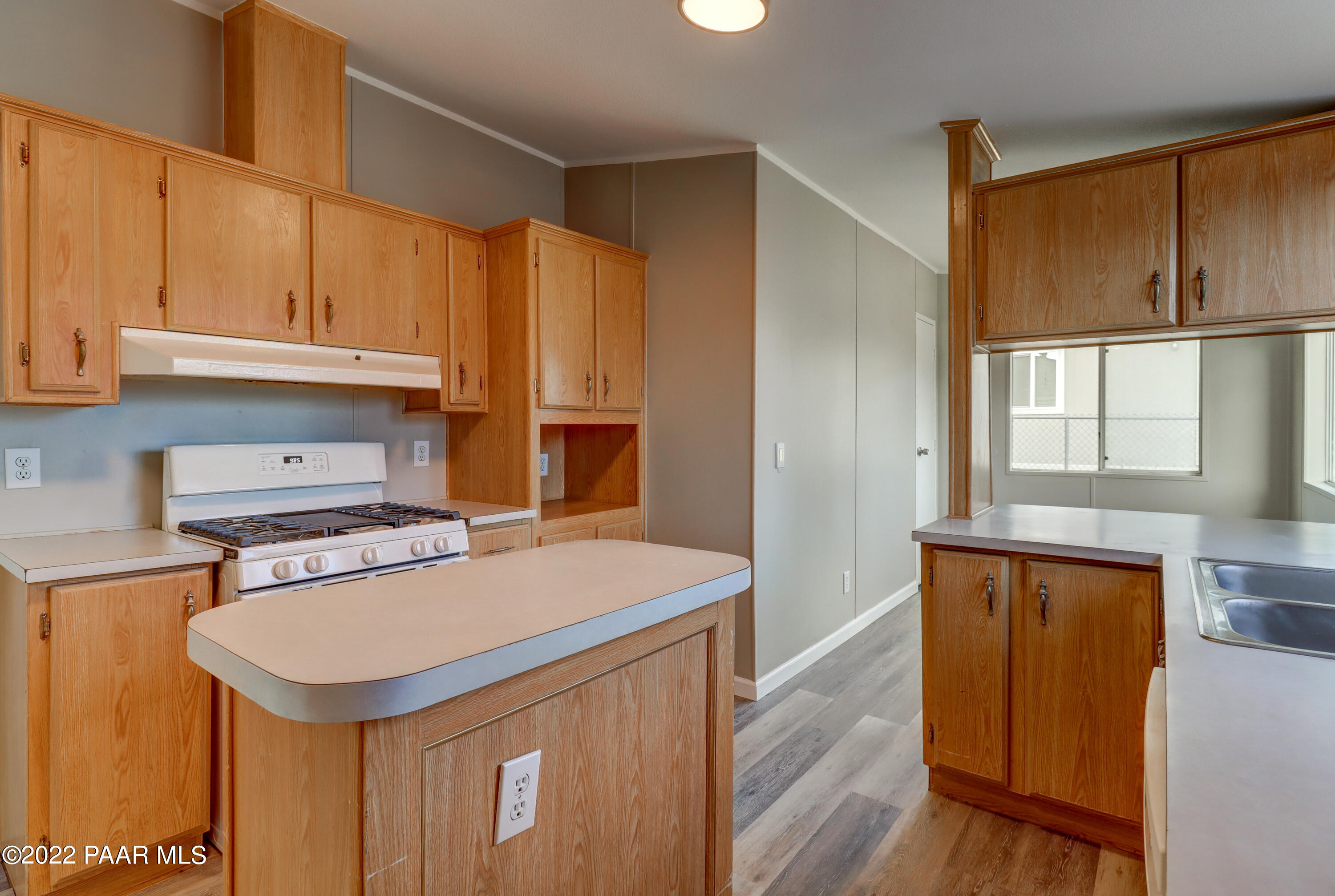 1330 Prairiegrass Road Chino Valley, AZ 86323 - Photo 3 of 31 a kitchen with stainless steel appliances cabinets and wooden floor