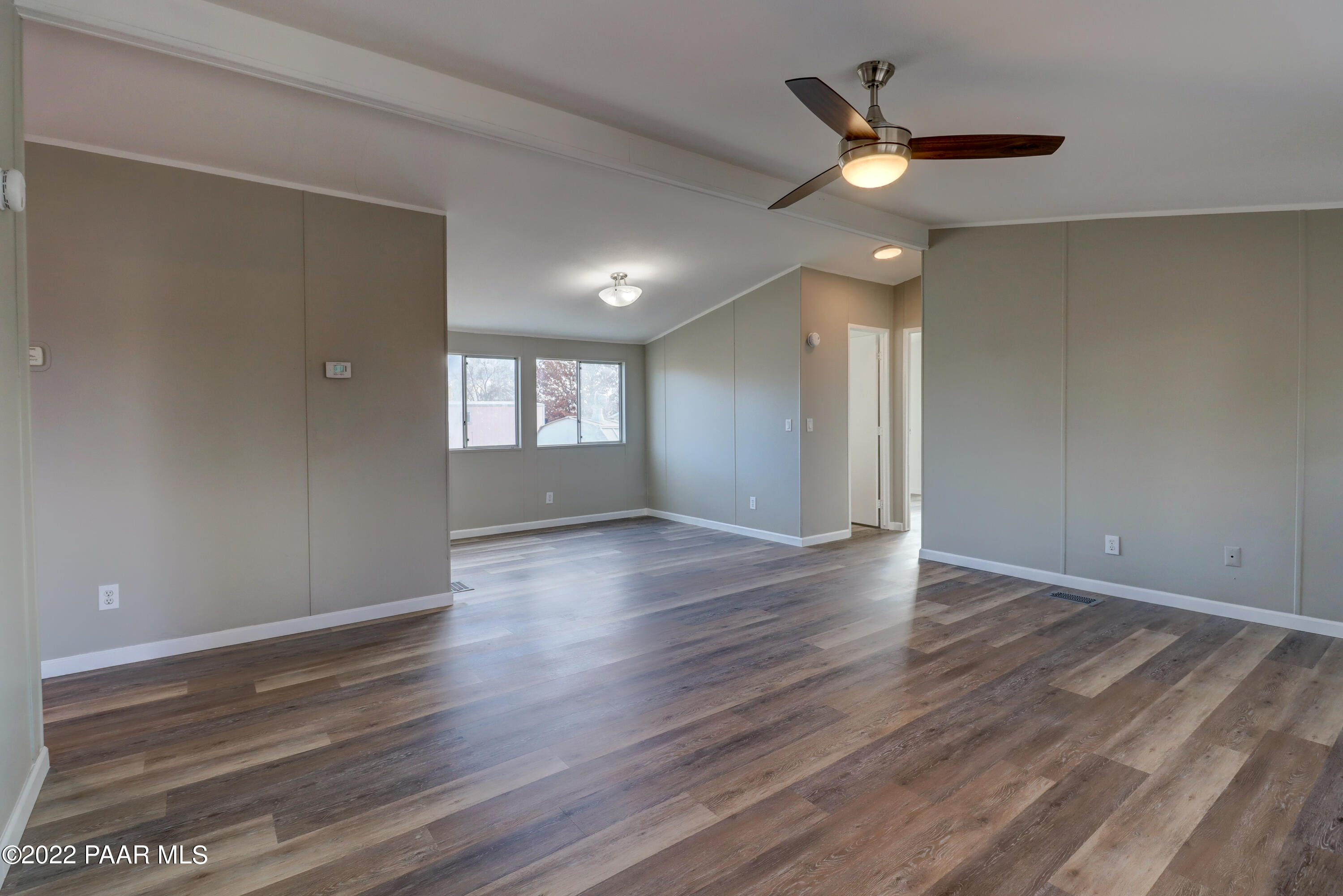 1330 Prairiegrass Road Chino Valley, AZ 86323 - Photo 9 of 31 an empty room with wooden floor and windows