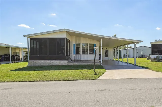 a view of a house with a swimming pool and a yard