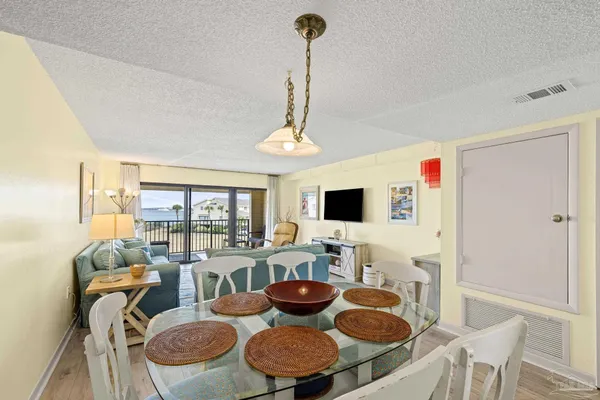 a living room with furniture a rug and a flat screen tv
