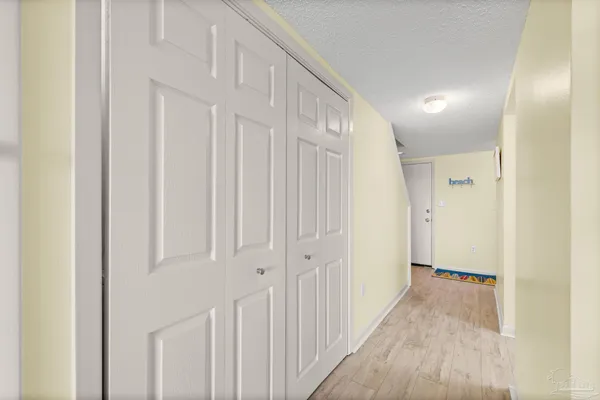 a view of a hallway with wooden floor and entryway