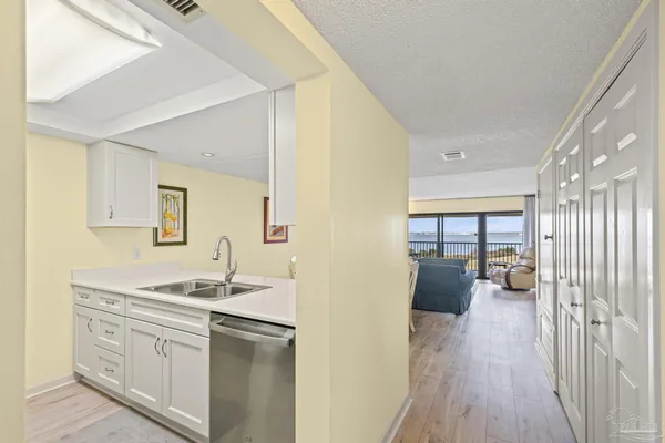 a kitchen with sink cabinets and refrigerator