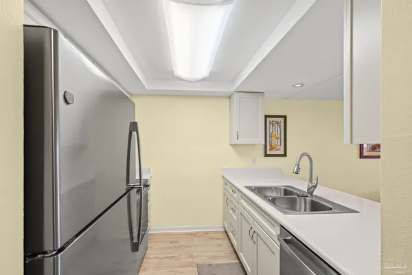 a bathroom with a granite countertop sink a mirror and a shower