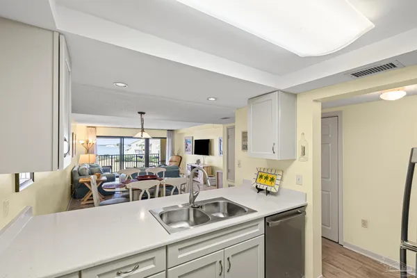 a kitchen with stainless steel appliances a refrigerator sink and cabinets