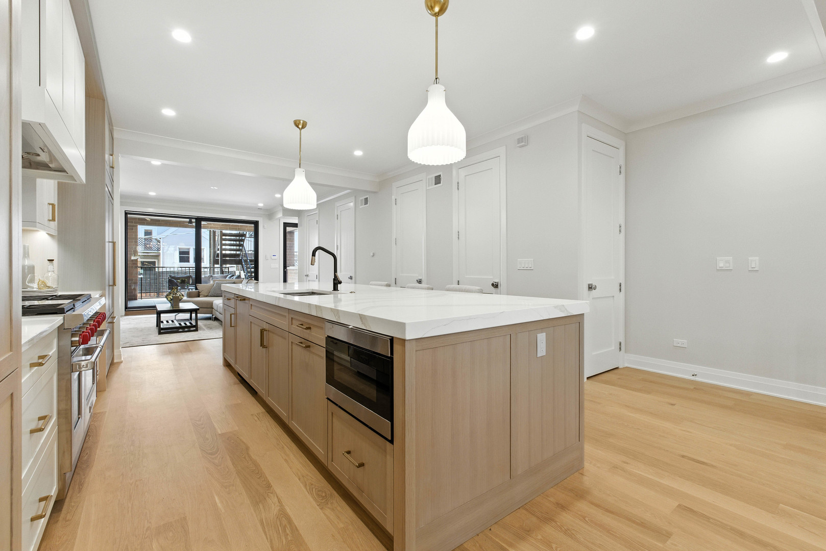 908 West Fullerton Avenue, Unit PH Chicago, IL 60614 - Photo 5 of 23 a large white kitchen with a large island oven a stove a sink and a refrigerator