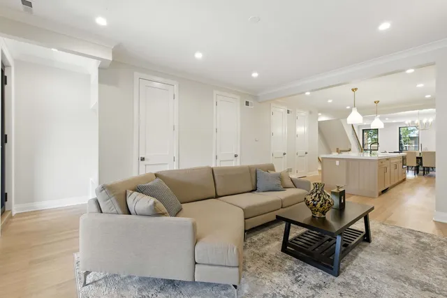 a living room with furniture kitchen view and a table
