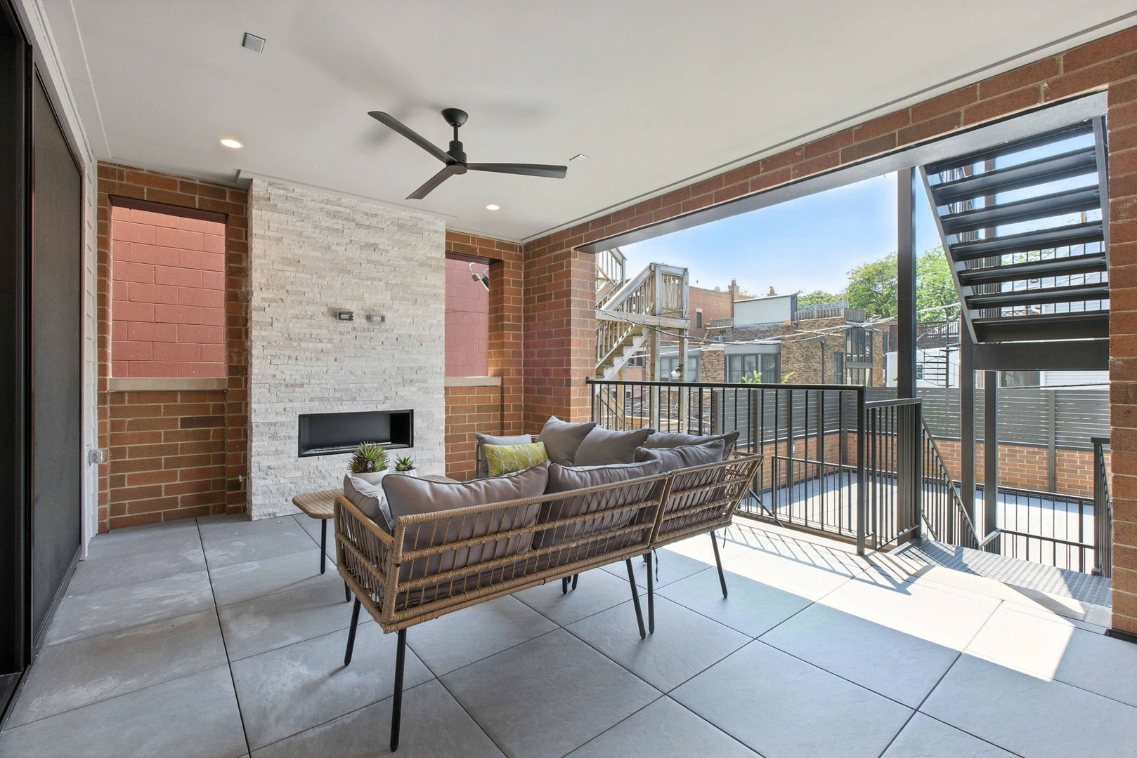 908 West Fullerton Avenue, Unit PH Chicago, IL 60614 - Photo 9 of 23 a living room with furniture a fireplace and a floor to ceiling window