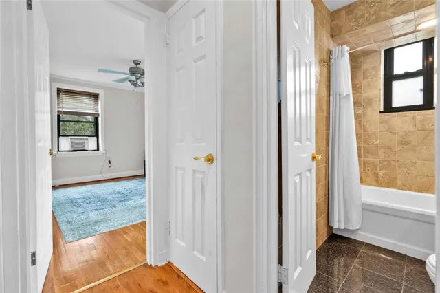 a bathroom with a granite countertop sink a toilet and bathtub
