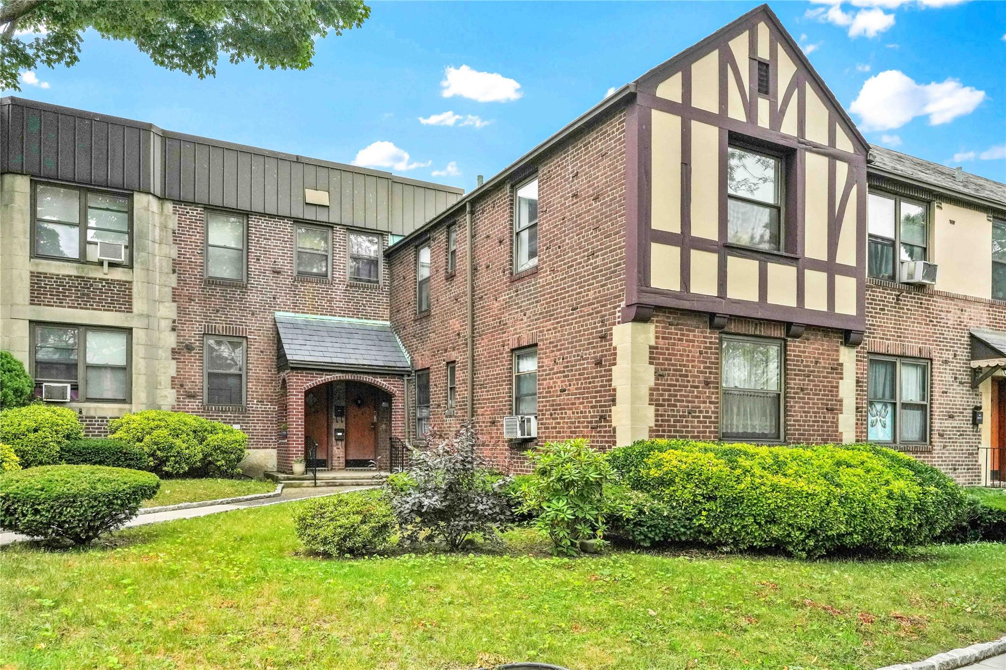 21-40 78th Street, Unit 2 Queens, NY 11370 - Photo 10 of 11 a front view of a house with a garden and plants