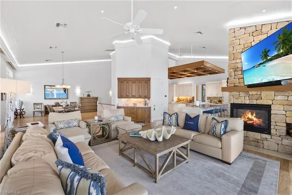 a view of a kitchen with furniture and wooden floor