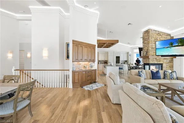 a living room with furniture fireplace and a large window
