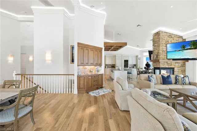 a living room with furniture fireplace and a large window
