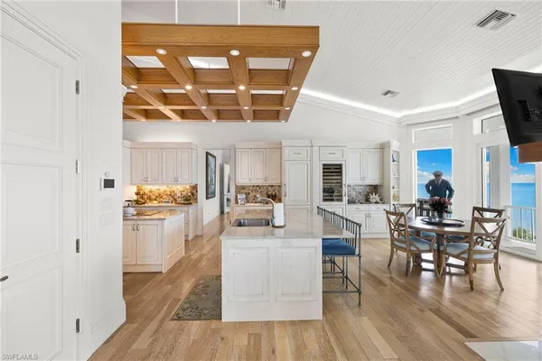 a dining room with furniture a fireplace and wooden floor