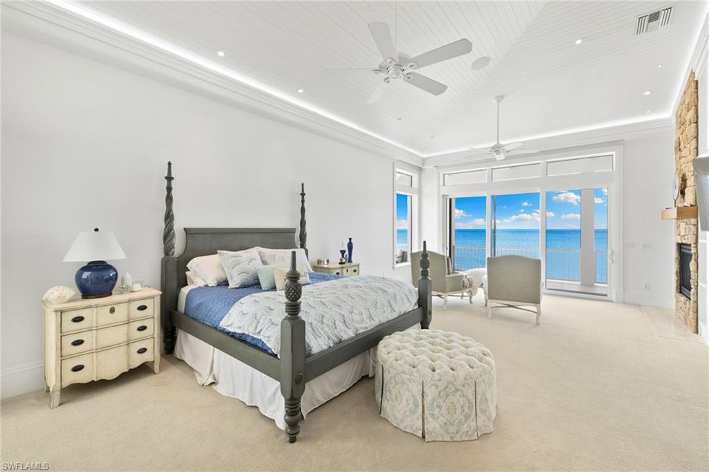 40 32nd Avenue South Naples, FL 34102 - Photo 27 of 49 Bedroom with carpet flooring, ceiling fan, access to outside, a stone fireplace, and recessed lighting