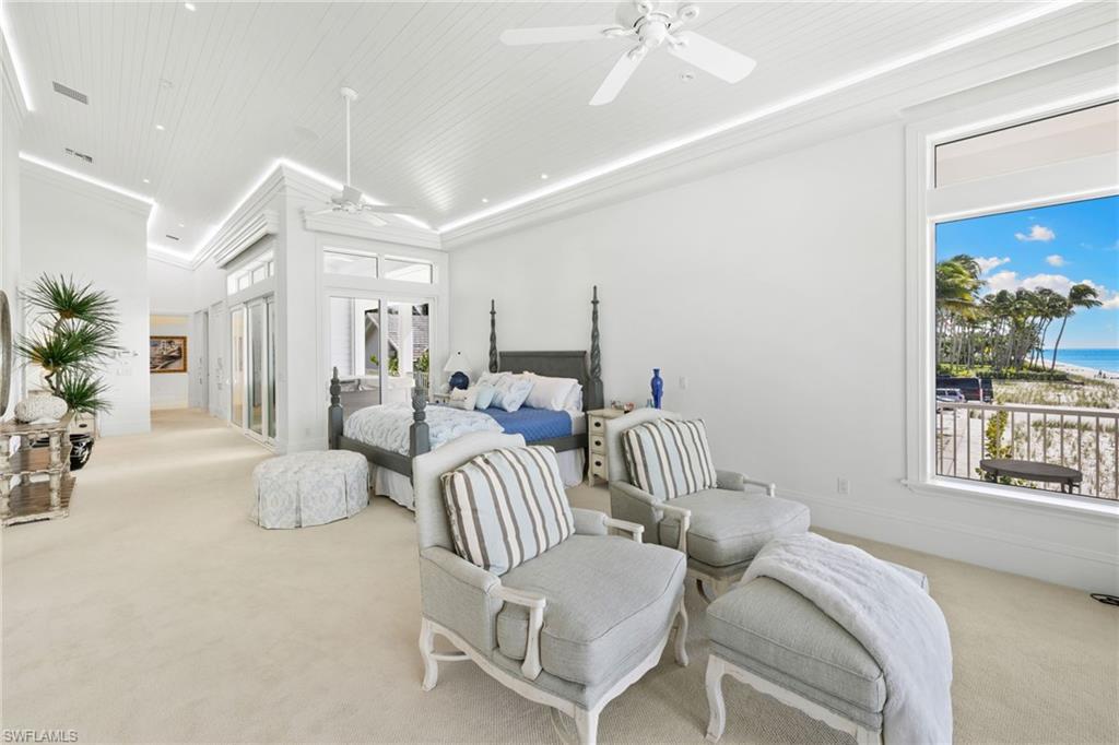 40 32nd Avenue South Naples, FL 34102 - Photo 28 of 49 Bedroom featuring light colored carpet, multiple windows, and a water view