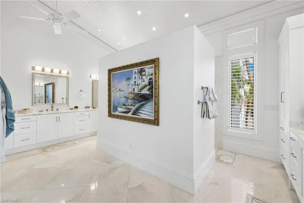 a bedroom with furniture and a large window