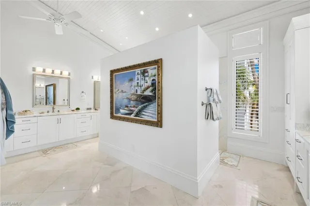 a bedroom with furniture and a large window