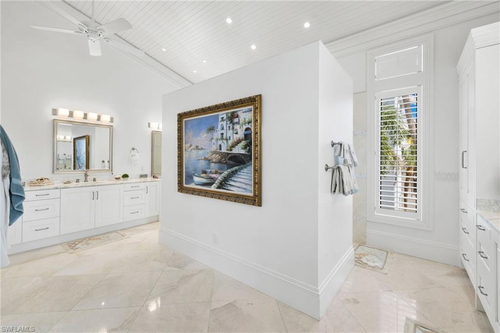40 32nd Avenue South Naples, FL 34102 - Photo 29 of 49 Bathroom featuring vanity, recessed lighting, ceiling fan, wooden ceiling, and a towering ceiling