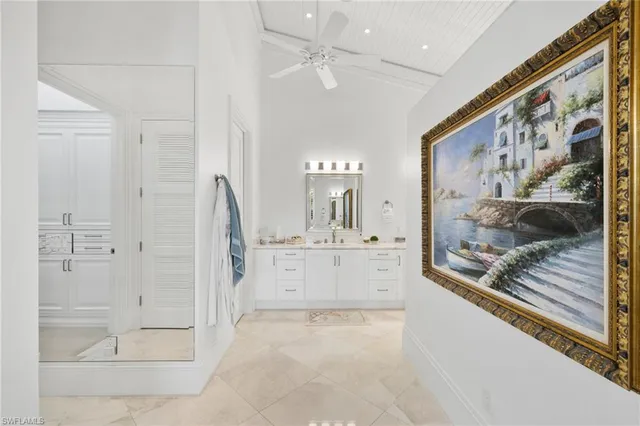 a view of a hallway with bathroom and a mirror
